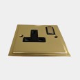 1 Gang 13A Switched Single Socket in Polished Brass and Black Trim Elite Stepped Flat Plate