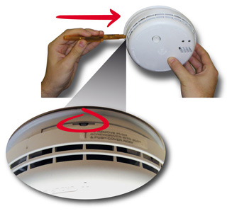 Step 2: Look for the alarm removal slot on the side of the alarm. There will be a label with a grey arrow pointing to the slot, along with the wording 'TO REMOVE, PUSH SCREWDRIVER INTO SLOT & PUSH COVER AWAY'. Push the tip of a small flat bladed screwdriver into the alarm removal slot. You only have to push it in around 1cm as this will be enough to release the locking latch inside. Make sure you keep the screwdriver horizontal (i.e. parallel to the ceiling) as inserting it at an angle could jam the locking latch